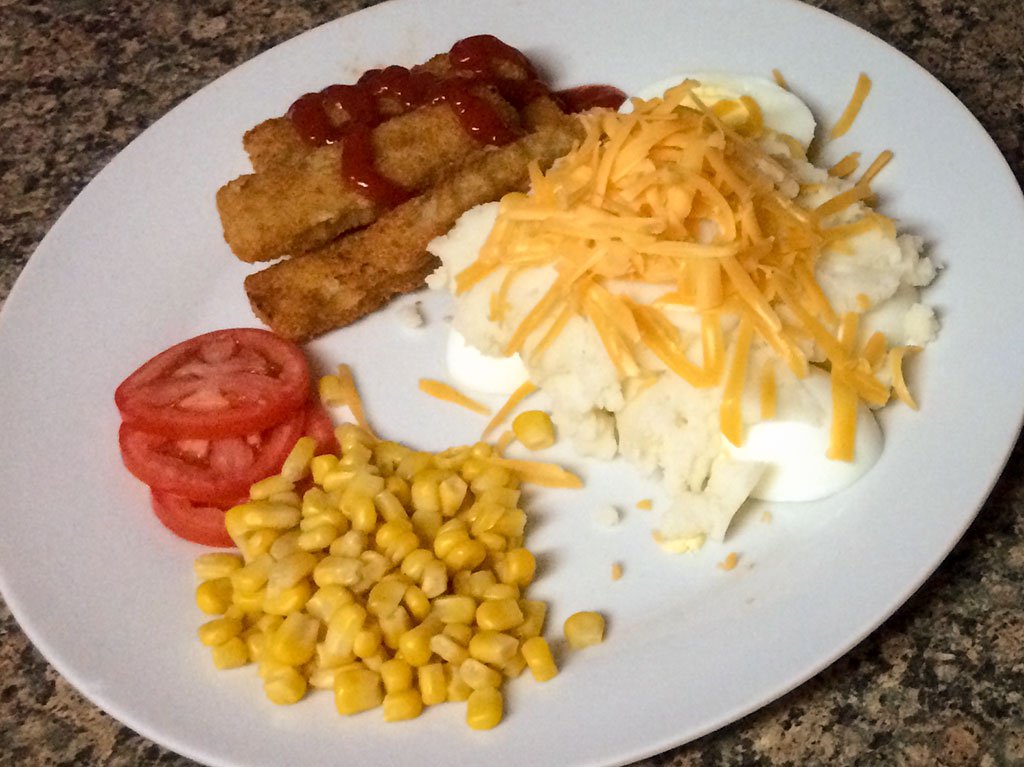 Fish fingers, mash with white sauce and vegetables - iPhone